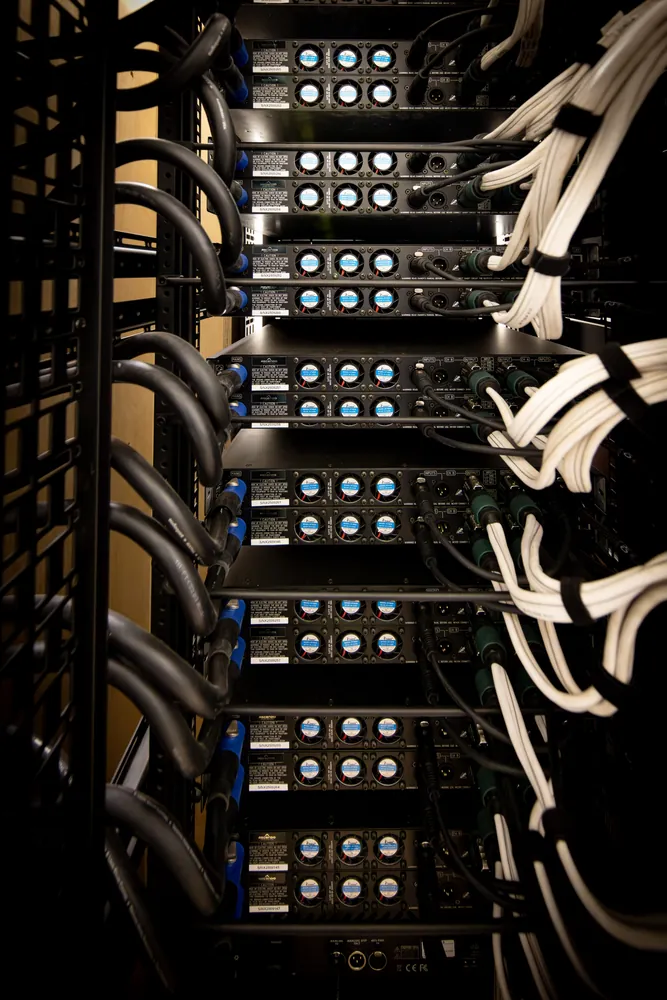 Rear of the subwoofer amplifier rack showing cable dressing