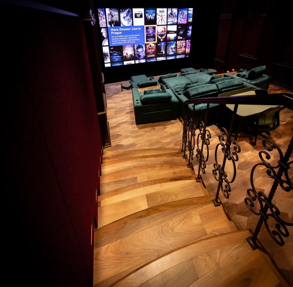 Entering the cinema down a timber staircase with a wrought iron balustrade