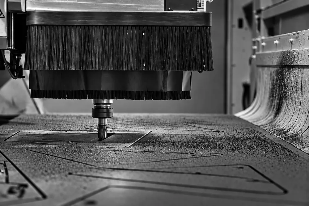 A CNC router cutting interior panels at the Officina Acustica factory in Italy