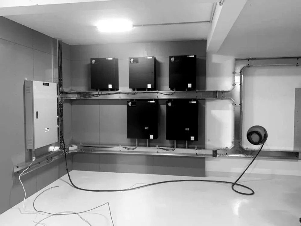Five Torus Power wall-mounted units installed beside a distribution board, with cable containment below