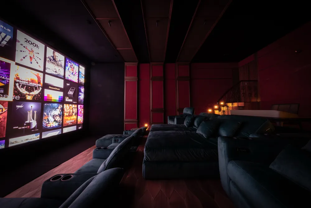 It's About Time private cinema, seen from the side of the room with the screen to the left and two rows of seating
