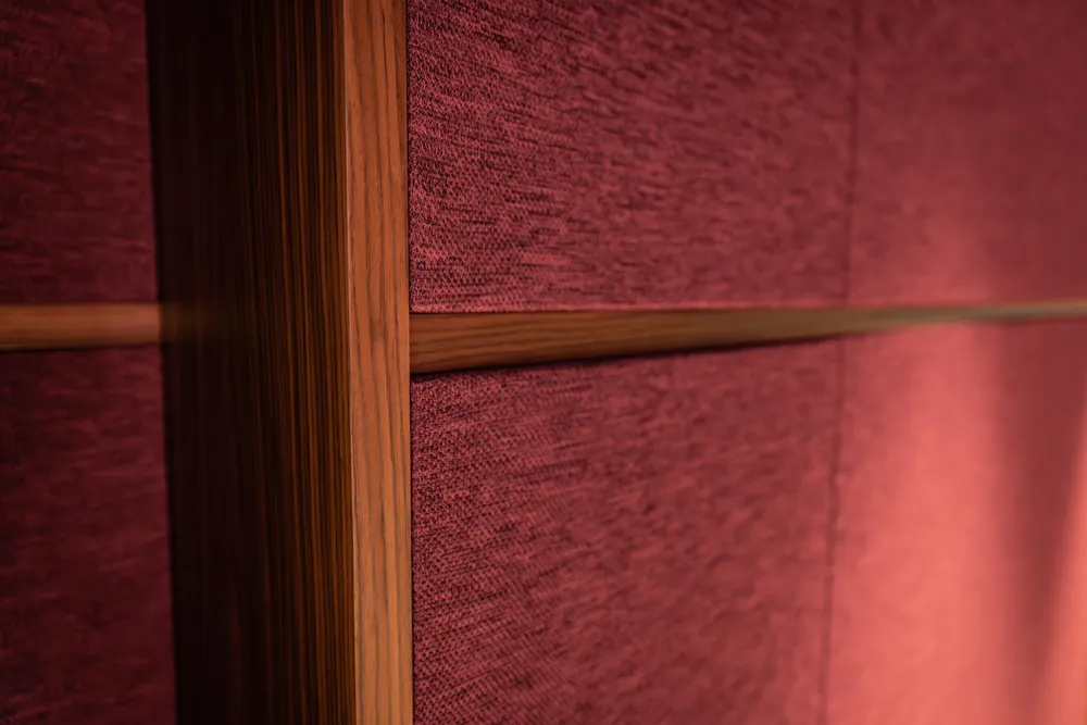 Close detail of fabric wall panels with timber trim